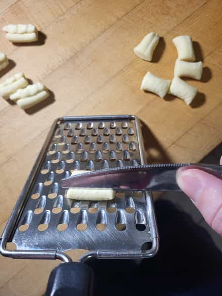 Rolling pasta on grater